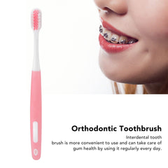 Pink handled interdental brush for daily gum care