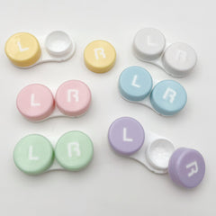 Six colorful contact lens cases with cleaner and left/right indicators for travel