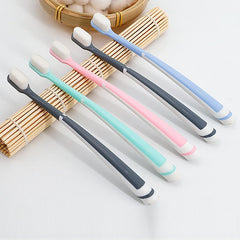Compact toothbrush head with soft bristles in use
