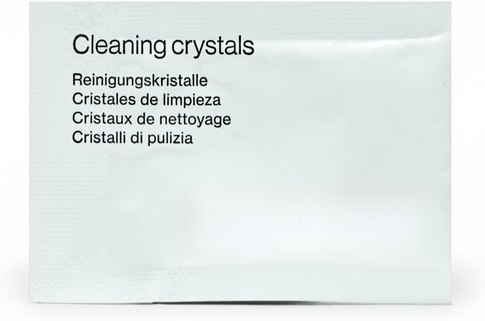 Clear aligners and retainers soaking in a cleaning dish