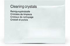 Clear aligners and retainers soaking in a cleaning dish