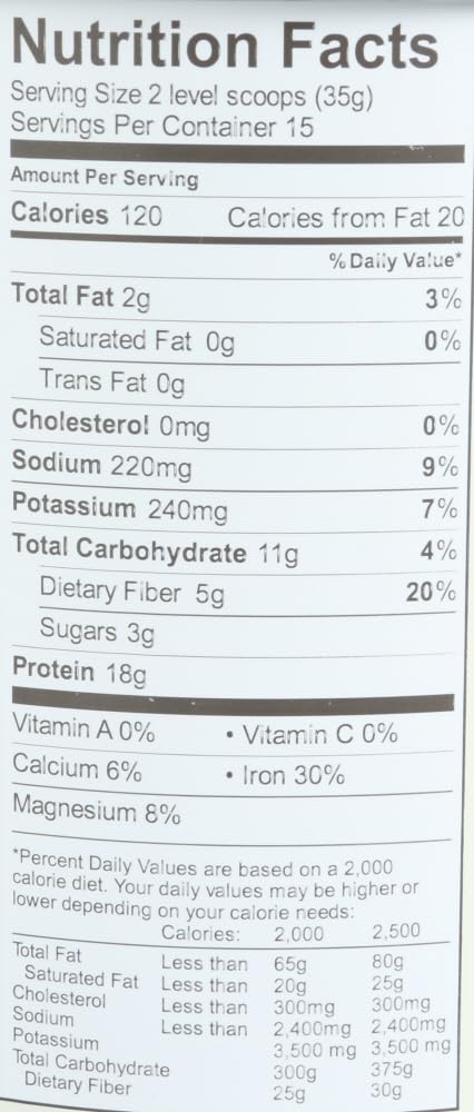 Vanilla protein powder ready to mix in a glass with spoon
