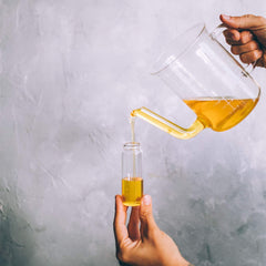 Dropper applying oil to skin