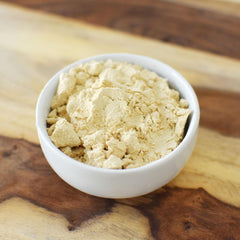 Unflavored and unsweetened pea protein powder in a measuring scoop