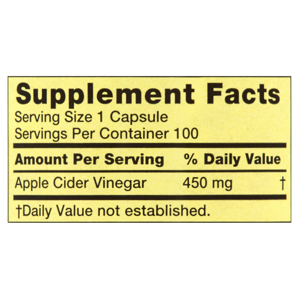 Bottle of Spring Valley ACV capsules with a glass of water