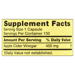 Bottle of Spring Valley ACV capsules with a glass of water
