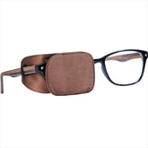 Astropic Silk Eye Patch in brown worn over glasses (medium)