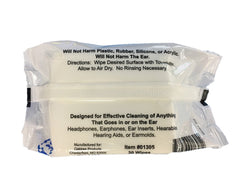 Close-up of a hearing aid being cleaned with an alcohol-free wipe