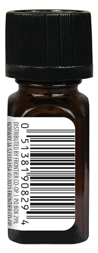 Close-up of cinnamon leaf essential oil bottle with dropper.