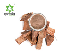 Arjuna bark powder in wooden scoop