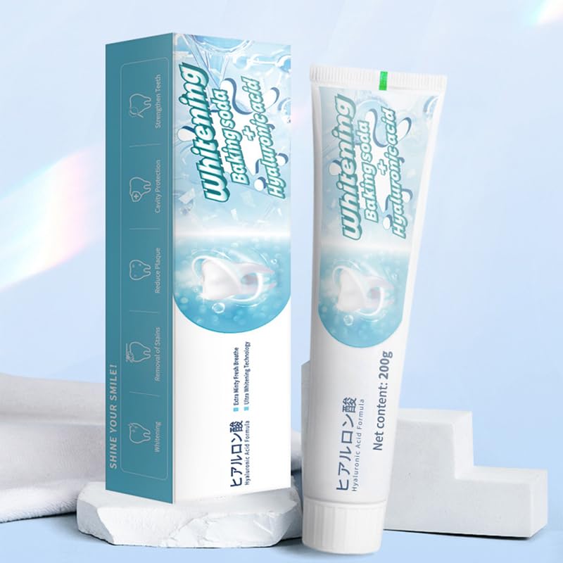 Fresh mint leaves and toothpaste packaging