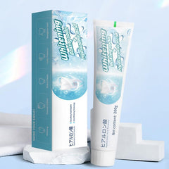 Fresh mint leaves and toothpaste packaging