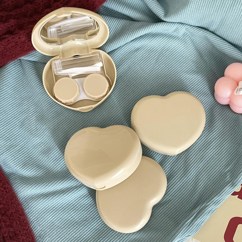 Open pack of 4 yellow heart-shaped lens cases with mirror