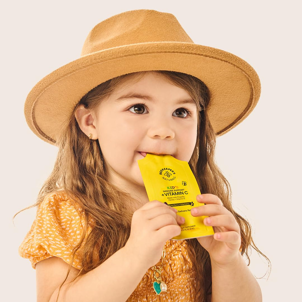 Beekeepers Naturals Kids Immune Liposomal Vitamin C sachet being squeezed into juice