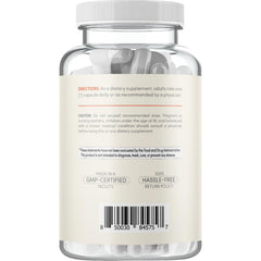 Capsule and bottle arranged on white background