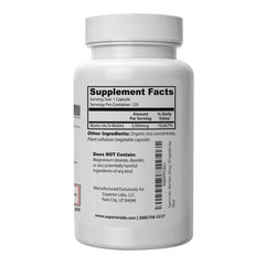 Open bottle with biotin capsules spilling onto a white surface