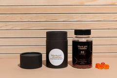 Lifestyle shot of a person taking Black Girl Vitamins D3 Gummies