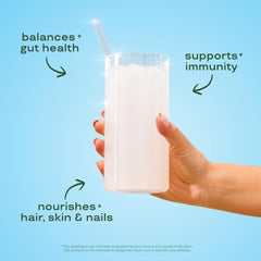 Close-up of unflavored colostrum powder in scoop with packaging