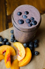 Bob's Red Mill hemp protein powder being poured into a smoothie for quick protein.