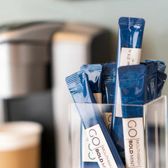 Guest bathroom display featuring Bold Mint GO mouthwash packets