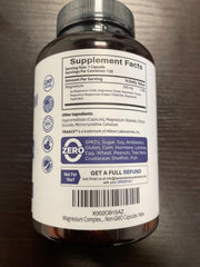 Bottle with capsules beside a glass of water