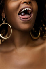 Bottle beside fresh strawberries and greenery