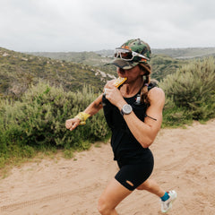 Runner holding a Go Gel Endurance Mango during a run