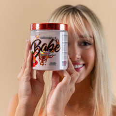 Woman exercising with Bucked Up Babe Pre Workout powder, Fruit Punch