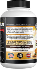 Two turmeric capsules on a wooden surface