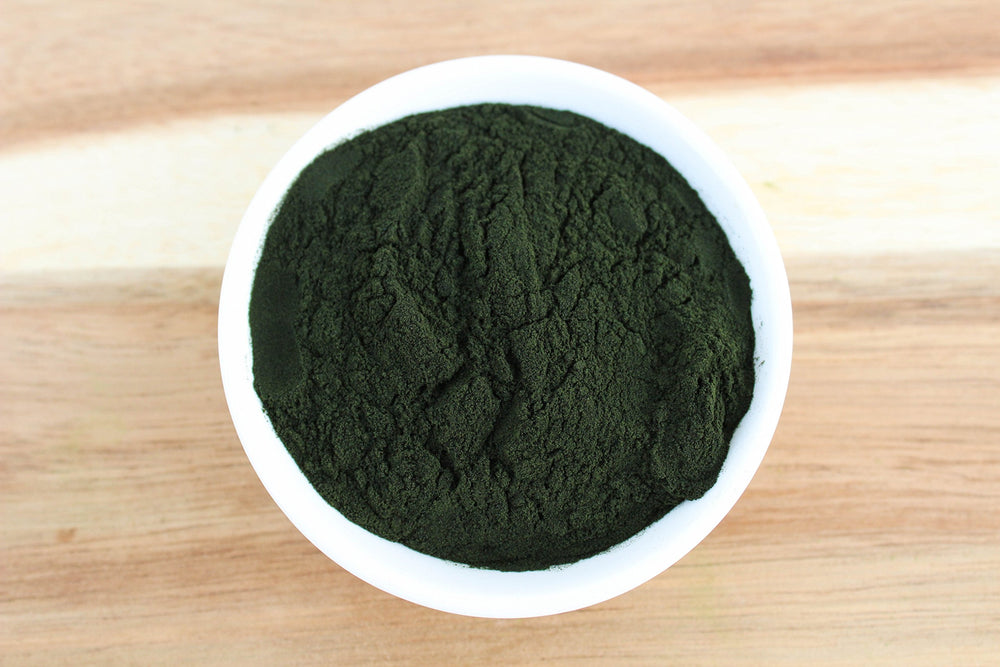 Chlorella powder organic and non-GMO certification labels on container