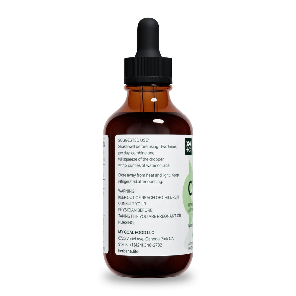 Glass with cilantro tincture next to a water bottle for dosage