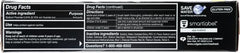 Open toothpaste tube showing gel and charcoal specks