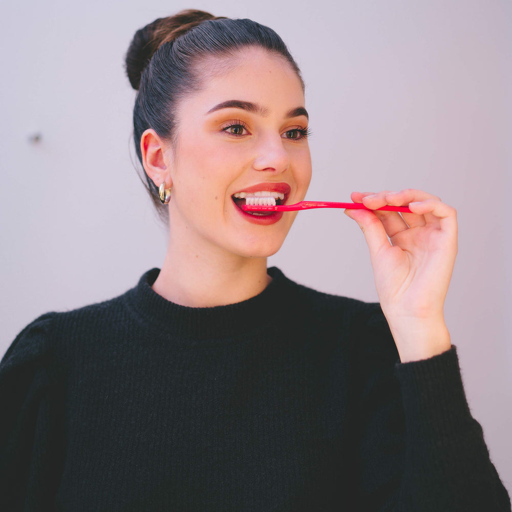 Toothbrush cleaning surfaces around braces