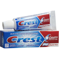 Toothbrush with Crest toothpaste mint flavor being applied