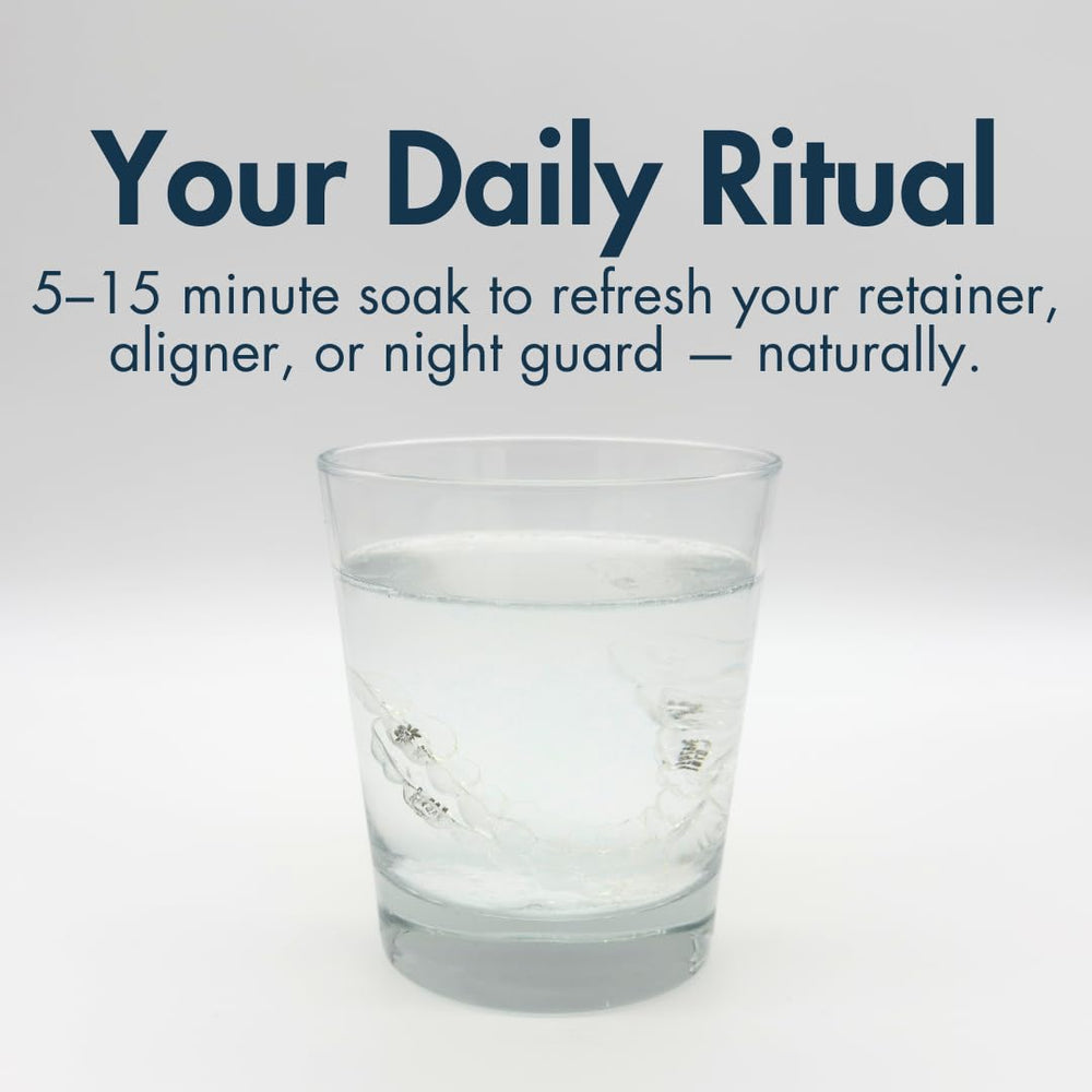 Dentures and mouthguards soaking during cleaning with The Daily Refresher