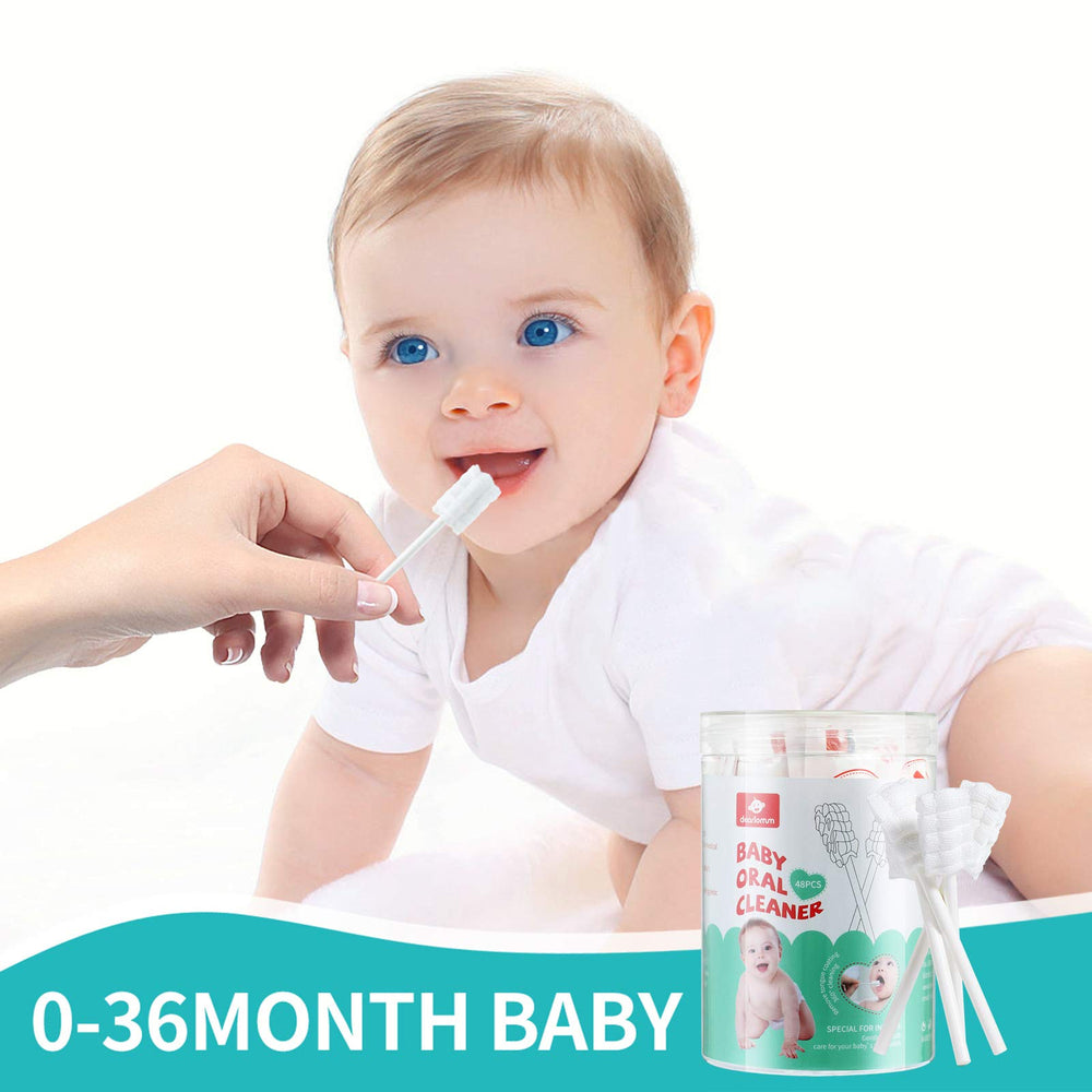 Gentle baby oral cleaning being used on infant gums