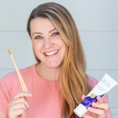Lifestyle image of person brushing teeth with Essentials Toothpaste