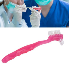 Pink denture brush designed for home and travel use