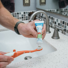 Flip cap designed for one-handed use