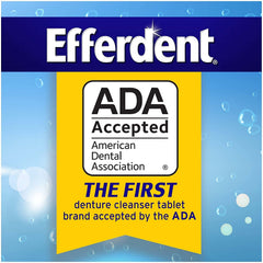 Hands cleaning dental appliances with Efferdent tablets