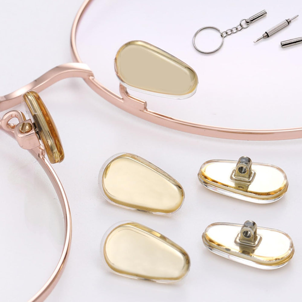 Screwdriver bits, screws, and tweezers in an eyeglass repair kit