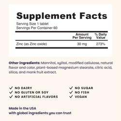 Dissolving zinc lozenges on tongue in blueberry flavor