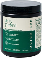 Factor Form Daily Greens powder jar and scoop on a clean surface