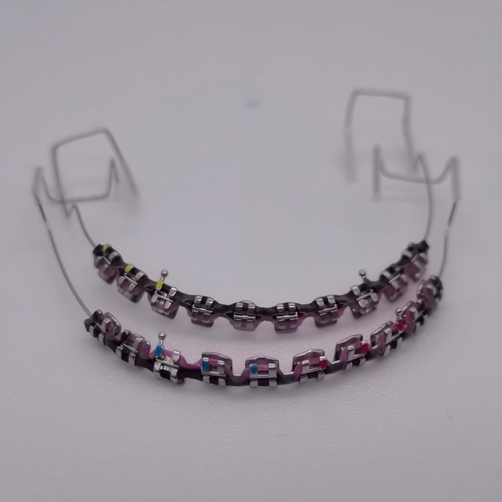 Metal brackets and wire with colorful power chains for dental practice
