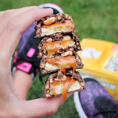 FITCRUNCH snack bar in hand ready for travel or gym bag use.