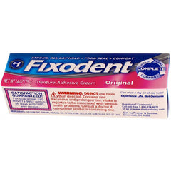 Person applying Fixodent Original for daily denture use