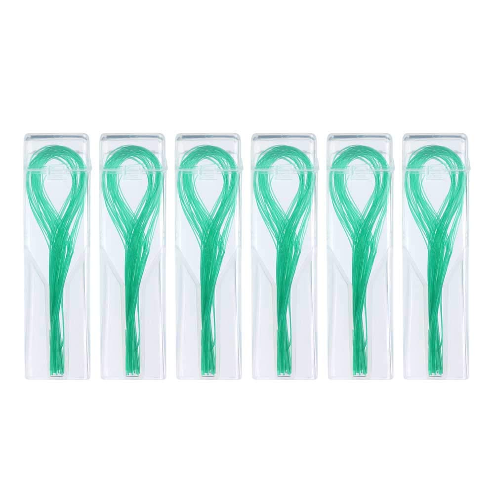 Close-up of green floss threader with flexible tip for tight spaces