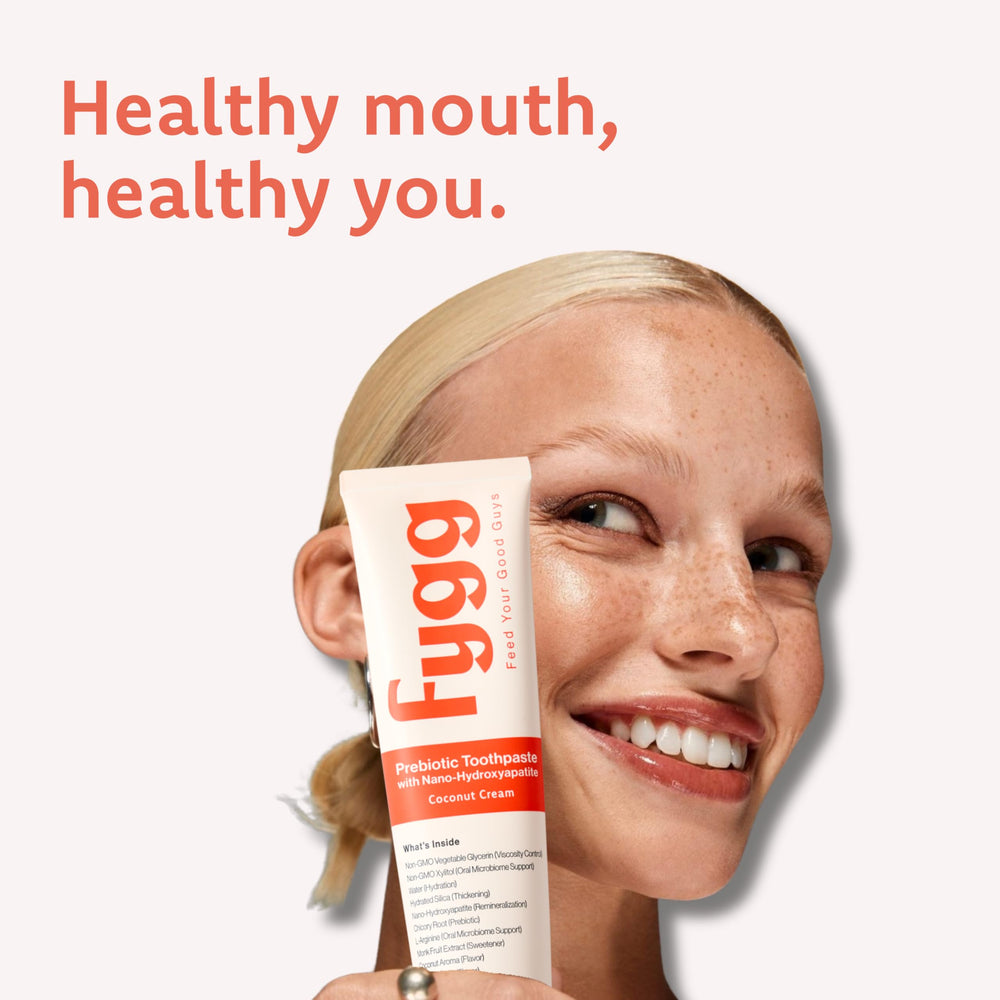 Toothpaste being dispensed onto a toothbrush with non-foaming formula