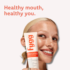 Toothpaste being dispensed onto a toothbrush with non-foaming formula