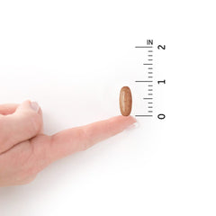 Close-up of daily dose tablet with packaging in the background